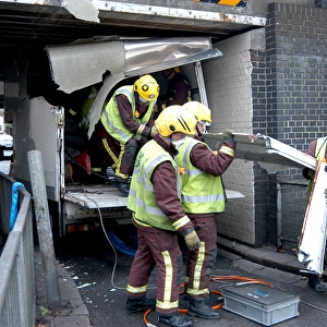 Firefighters working to remove van trapped under bridge