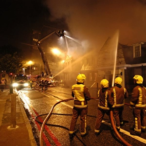 Firefighters working at scene of pub fire, SE London