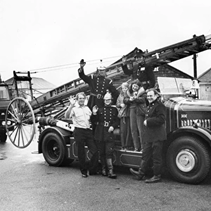 Firemen and children with 1927 Dennis fire engine