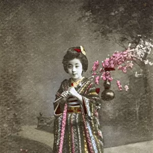 Japan - Young Japanese Girl holding cherry blossom frond
