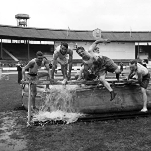 LFB firefighters in water dip, obstacle race