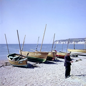 Man with boats and fishing nets at Seaton, Devon