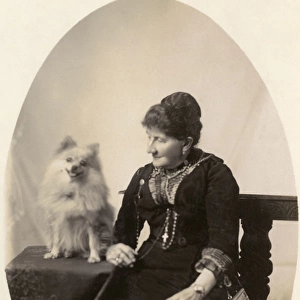 Middle aged woman with dog in studio photo