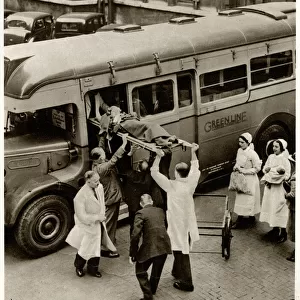 Patient on stretcher lifted onto evacuation coach 1939