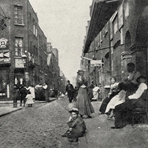 People sitting on street, Whitechapel, East London