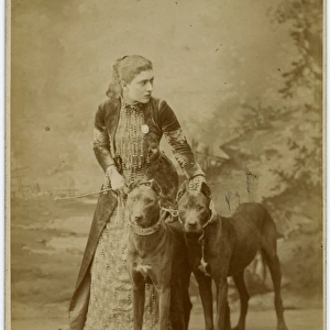 Studio portrait, young woman with two dogs