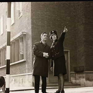 Woman police officer giving directions on a London street