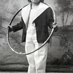 Young child posing in a sailors outfit holding a hoop - A Little Jack Tar - We All Love