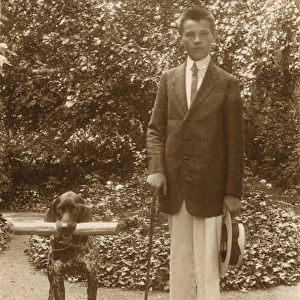 Young man with a dog in a garden