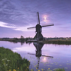 Windmill and moon reflected in the canal, Kinderdijk, Molenlanden, South Holland