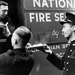 AFS firefighters being served from mobile kitchen, WW2
