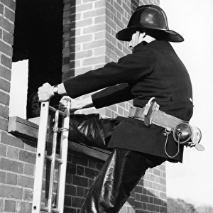 Firefighter during hook ladder practice