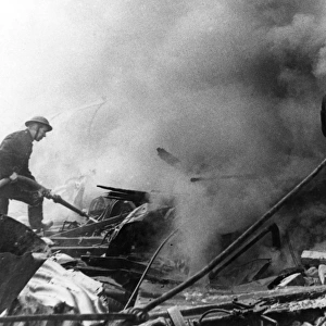 Firefighters in action after air raid, WW2