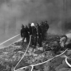 Firefighters in action with hosepipes, Poplar, East London