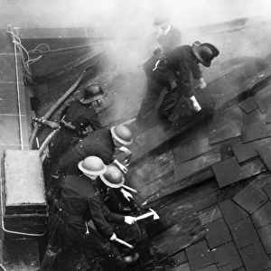 Firefighters cutting through a roof