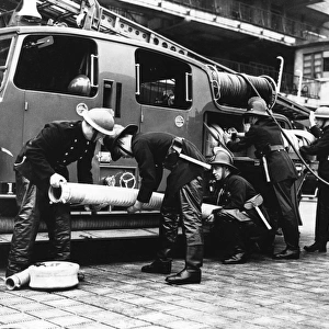 Firefighters with fire engine and appliances, WW2