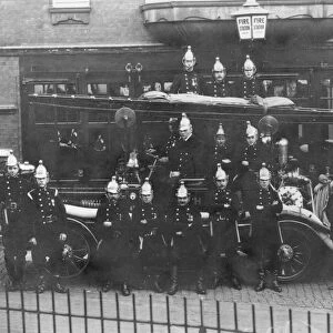 Firefighters and fire engine posing outside station