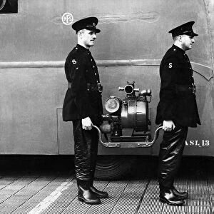 Two firefighters with salvage van and light pump, WW2