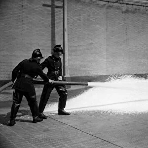 Firefighters training with foam extinguisher