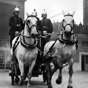 Horse-drawn fire vehicle and crew in display