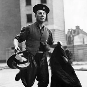 LFB firefighter in a hurry, with coat and helmet