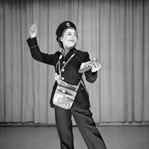 Woman performing as a bus conductor in a comic sketch