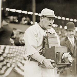 BASEBALL: CAMERA, c1911. Herman A. Germany Schaefer, baseball player for the Washington Senators, using a camera, New York. Photograph, c1911