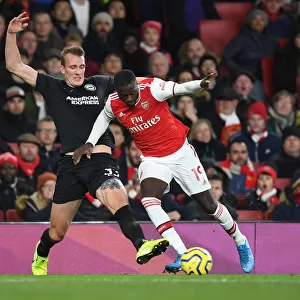 Arsenal's Nicolas Pepe Battles Dan Burn in Intense Arsenal v Brighton Clash, Premier League 2019-20