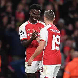 Arsenal's Trossard and Saka Celebrate First Goal Against Sevilla in 2023-24 UEFA Champions League