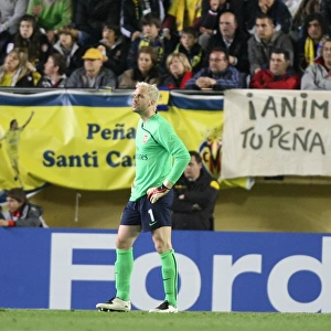 Injured Arsenal goalkeeper Manuel Almunal leaves the field