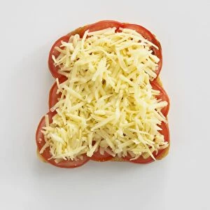 Grated cheese and sliced tomatoes on toast