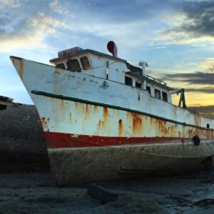 Vintage Fishing Boat at Low Tide at Sunset