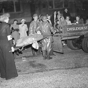 Casualties are being loaded into the back of a lorry during an air raid drill