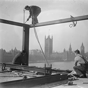 He looks down on Parliament. A welder on a precarious perch high above the Albert Embankment