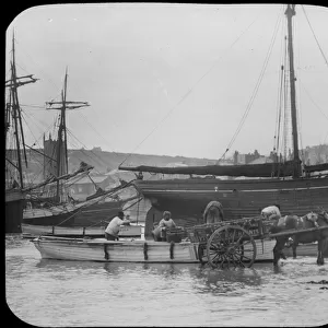Unloading fish from a boat into a horse and cart, St Ives harbour, Cornwall. Early 1900s