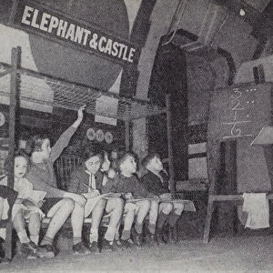 Children taking an evening class at Elephant and Castle Station on the London Underground during the Blitz, World War II, 1940 (b / w photo)