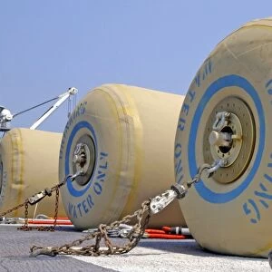 Rubber bladders full of drinking water wait for transport on the flight deck of USS