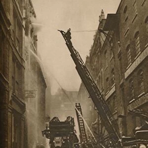 How The London Fire Brigade Comes To Grips With Its Enemy, c1935. Creator: Unknown