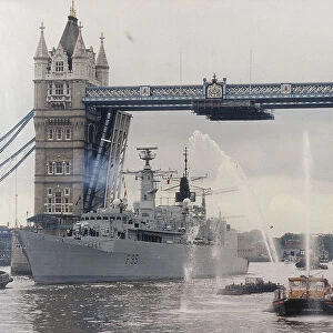 View of HMS London sailing beneath Tower Bridge, London, 1988