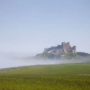 Bamburgh Castle On A Hill In The Fog; Northumberland England