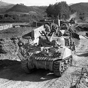Canadian armour crossing a Bailey Bridge over the River Sieve, Italy