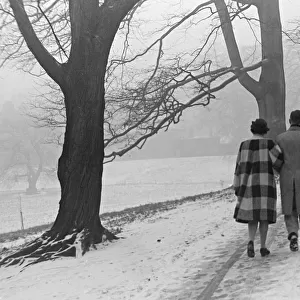A couple walking in a snowy Regents Park London January 1942