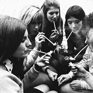 Female students smoke pipes for a contest in 1969