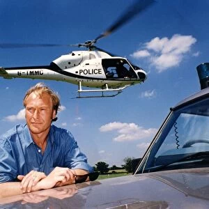 A helicoper hovers above the head of actor Nigel Le Vaillant in a field at Studley Grange