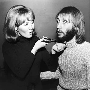 Lulu singer giving husband Maurice Gibb of the Bee Gees a shave