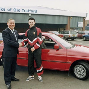 Manchester United footballer Ryan Giggs accepts the keys to his new car from Jim Quick
