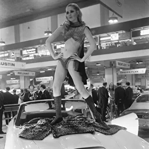 Model poses on the bonnet of a Aston Martin Volante at Motor Show 15th October 1968