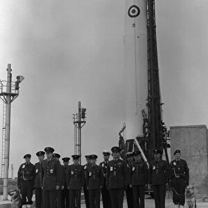 The officers and men who form the launch crew standing in front of a Thor
