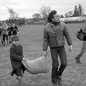 Pupil, Aiden Reeve and TV presenter, Chris Wenner is seen here carrying the sack full of
