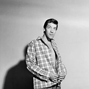 Singer Michael Holliday poses wearing check shirt. 24th November 1957